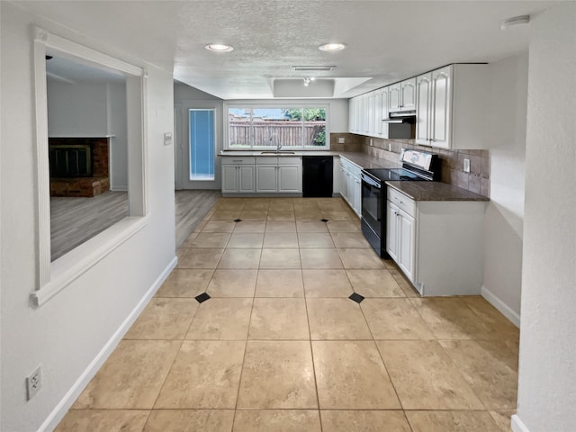 kitchen featuring dishwasher, decorative backsplash, white cabinetry, range with electric cooktop, and sink