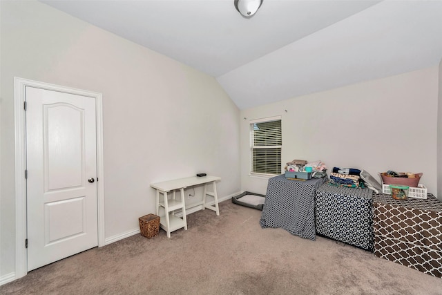 misc room with light colored carpet and vaulted ceiling