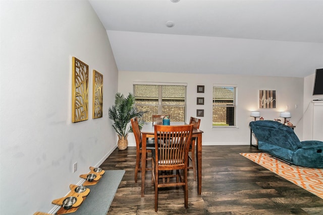 dining space featuring lofted ceiling and dark hardwood / wood-style flooring