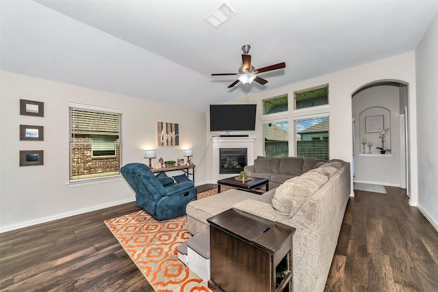 living room featuring ceiling fan, dark hardwood / wood-style flooring, and vaulted ceiling