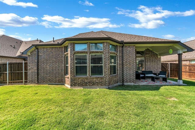 rear view of house featuring a patio and a yard