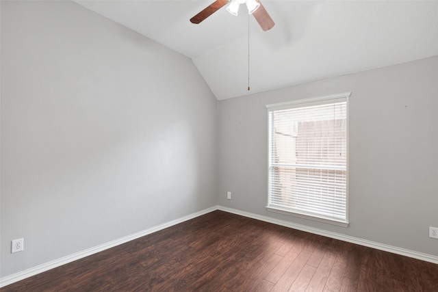 empty room with ceiling fan, hardwood / wood-style floors, and lofted ceiling