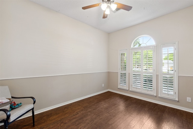 empty room featuring ceiling fan and dark hardwood / wood-style flooring