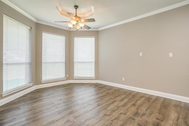 empty room with ornamental molding, dark wood-style flooring, and plenty of natural light