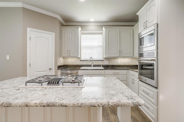 kitchen with white cabinets, stainless steel appliances, and a sink