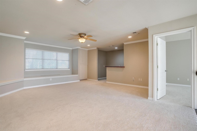 empty room featuring recessed lighting, baseboards, crown molding, and light colored carpet