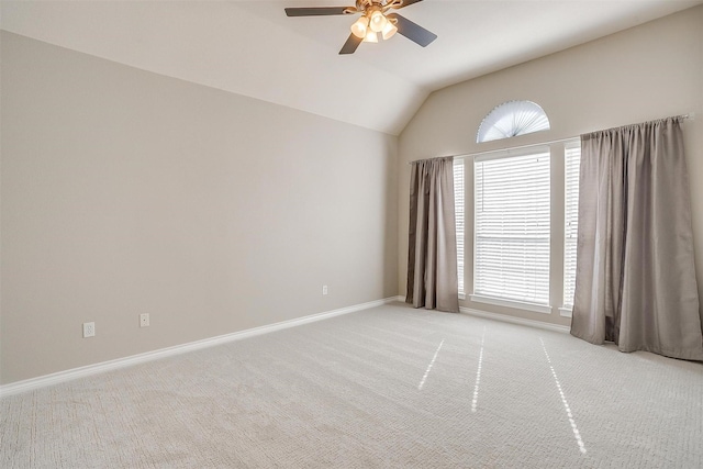 unfurnished room with lofted ceiling, light colored carpet, ceiling fan, and baseboards