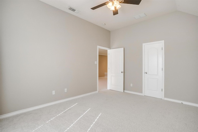 unfurnished bedroom with baseboards, visible vents, lofted ceiling, ceiling fan, and carpet flooring