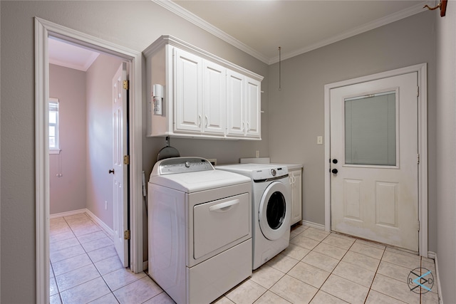 washroom with cabinets, light tile patterned floors, ornamental molding, and washing machine and clothes dryer