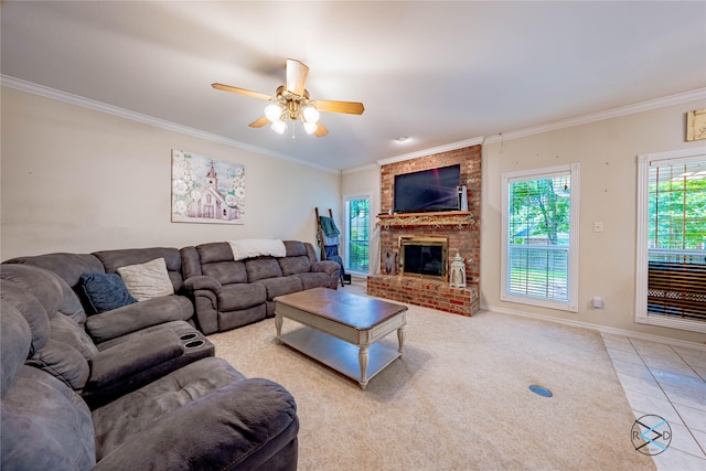 living room with a brick fireplace, ceiling fan, crown molding, and light tile patterned flooring