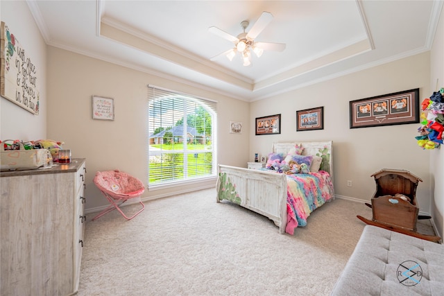 bedroom featuring a raised ceiling, ceiling fan, crown molding, and carpet floors