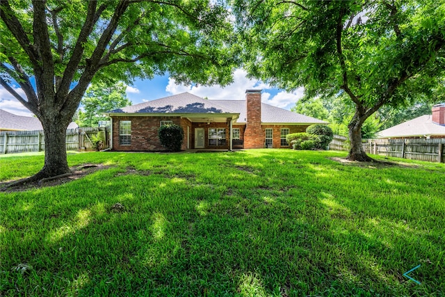 rear view of house with a yard