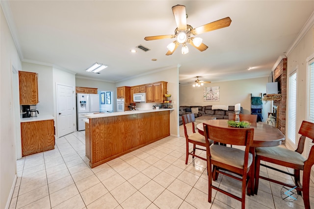 kitchen with light tile patterned floors, white appliances, crown molding, kitchen peninsula, and ceiling fan