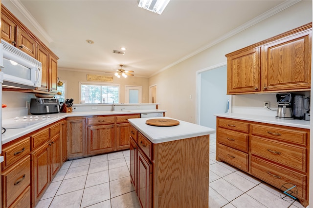 kitchen featuring white appliances, crown molding, light tile patterned floors, and a kitchen island