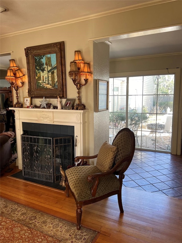 sitting room featuring ornamental molding and hardwood / wood-style floors