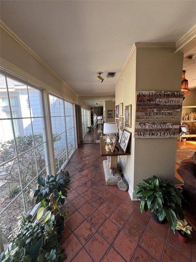 interior space with ornamental molding and dark tile floors