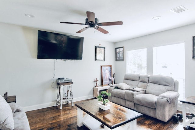 living room featuring dark hardwood / wood-style flooring and ceiling fan