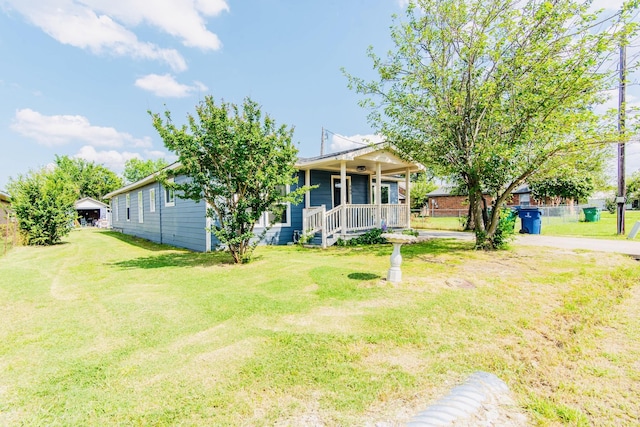 view of front of property with covered porch and a front yard