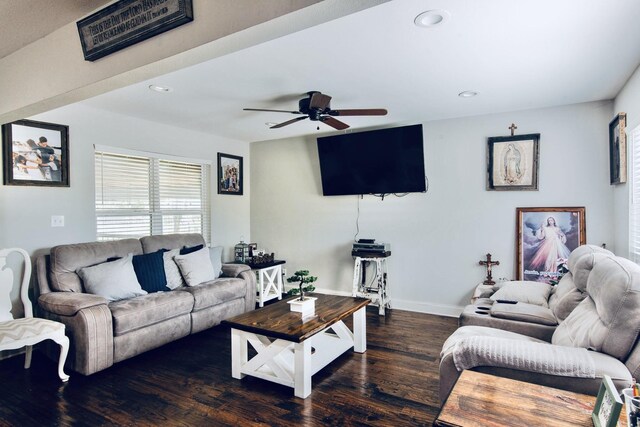 living room featuring ceiling fan and dark hardwood / wood-style flooring