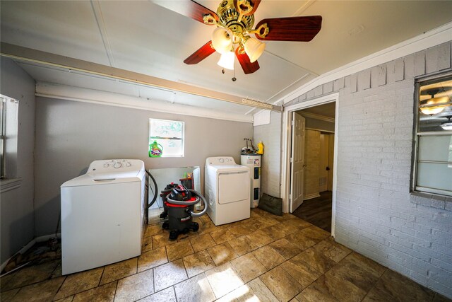 washroom featuring dark tile flooring, ceiling fan, washer and clothes dryer, and electric water heater