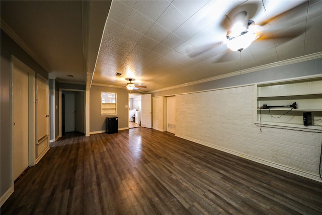 unfurnished living room featuring ceiling fan, ornamental molding, and dark hardwood / wood-style flooring