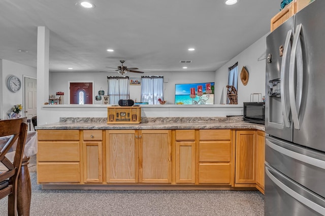 kitchen with kitchen peninsula, stainless steel refrigerator with ice dispenser, ceiling fan, and light brown cabinetry