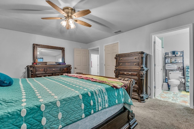 carpeted bedroom with ceiling fan and connected bathroom