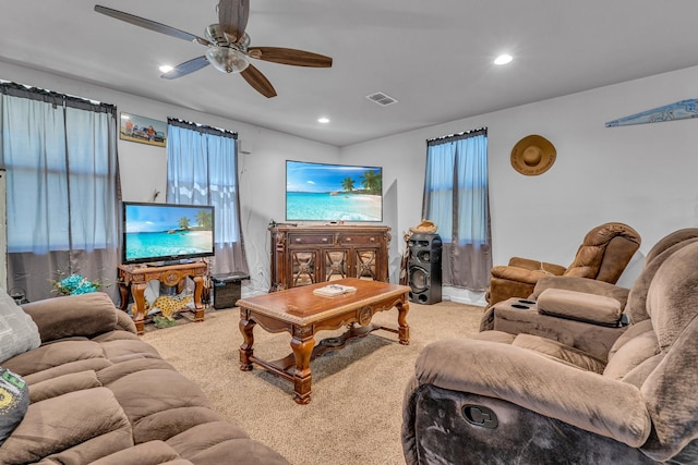 living room featuring carpet flooring and ceiling fan