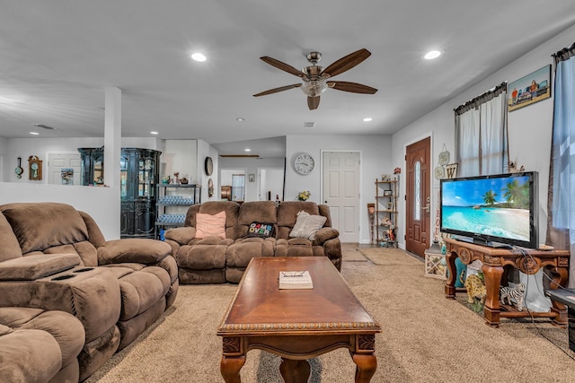 carpeted living room with ceiling fan