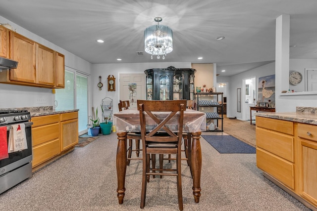 dining space with light colored carpet and an inviting chandelier