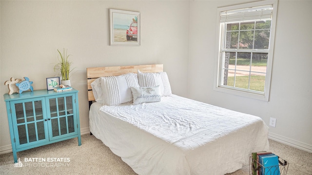 bedroom with light carpet and multiple windows