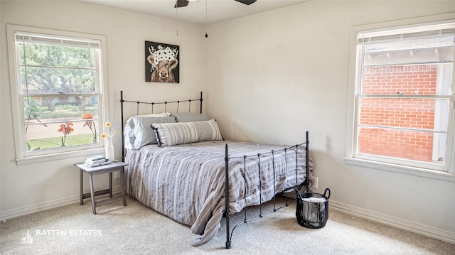 bedroom featuring ceiling fan, multiple windows, and carpet