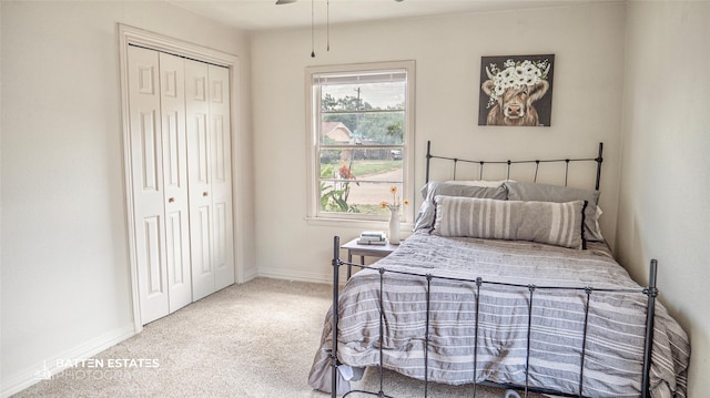 carpeted bedroom featuring ceiling fan and a closet