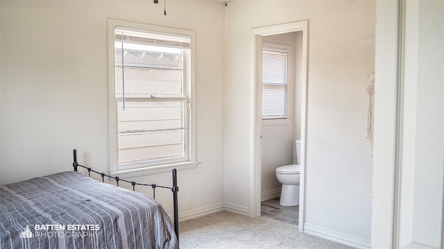 carpeted bedroom with connected bathroom