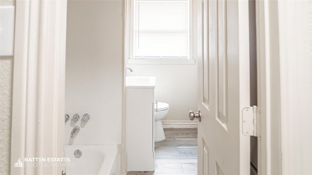 full bathroom with toilet, vanity,  shower combination, and hardwood / wood-style floors