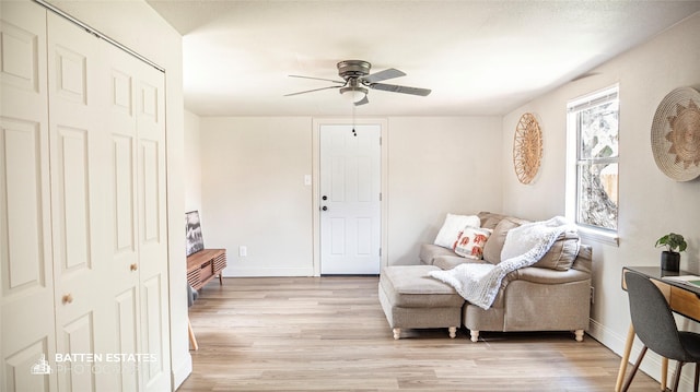 living area with ceiling fan and light wood-type flooring