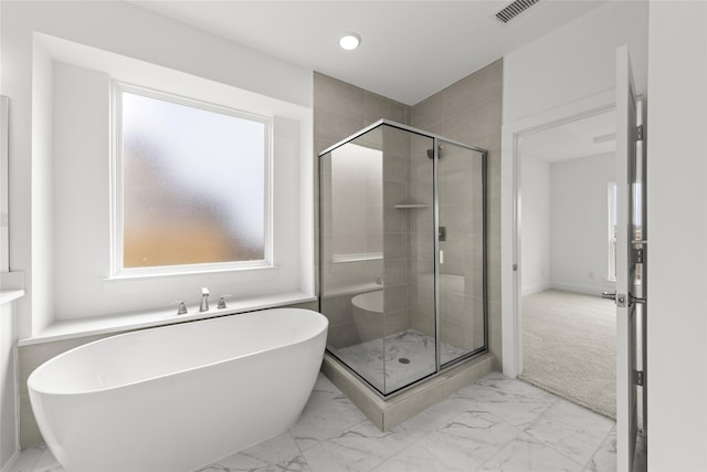 1727 Newport Dr, Cedar Hill, TX 75104 - bathroom with marble look tiles, a stall shower, a freestanding bath, and recessed lighting