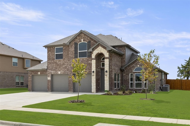 view of front of home with a garage, cooling unit, and a front yard