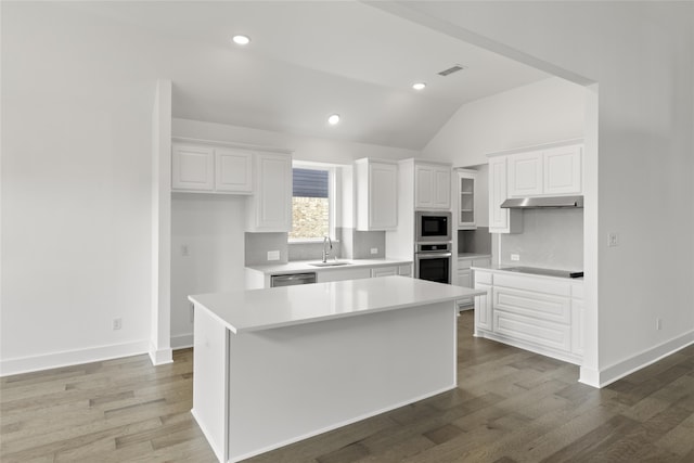 kitchen featuring white cabinetry, appliances with stainless steel finishes, sink, and a center island