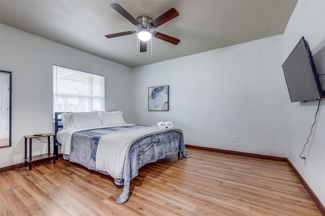 bedroom with light hardwood / wood-style flooring and ceiling fan