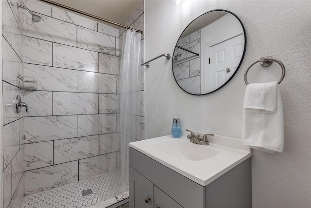 bathroom featuring vanity and curtained shower