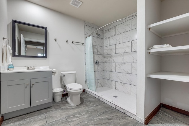 bathroom featuring vanity, curtained shower, and toilet