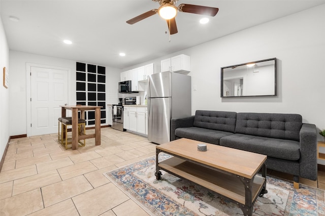 living room featuring light tile patterned floors and ceiling fan