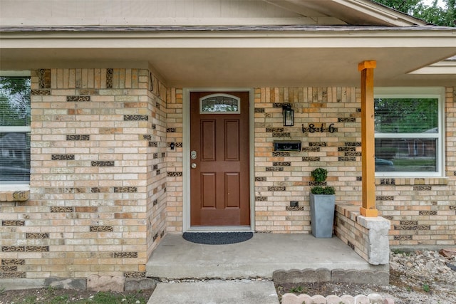 view of exterior entry featuring a porch