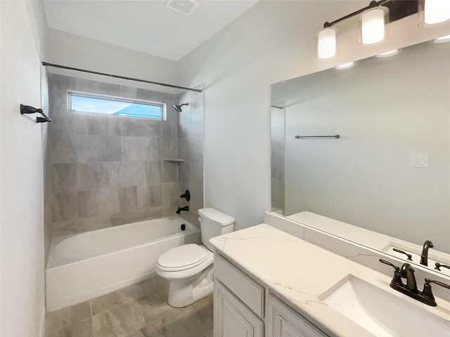 full bathroom featuring toilet, vanity, and tiled shower / bath