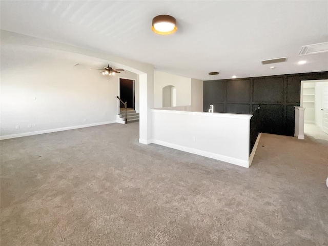 interior space featuring ceiling fan and carpet floors