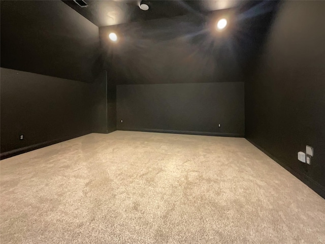 bonus room featuring vaulted ceiling and light carpet