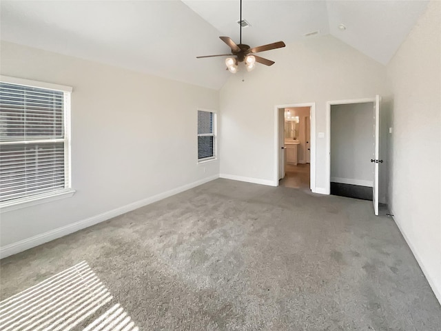 unfurnished bedroom with lofted ceiling, ensuite bath, ceiling fan, and carpet