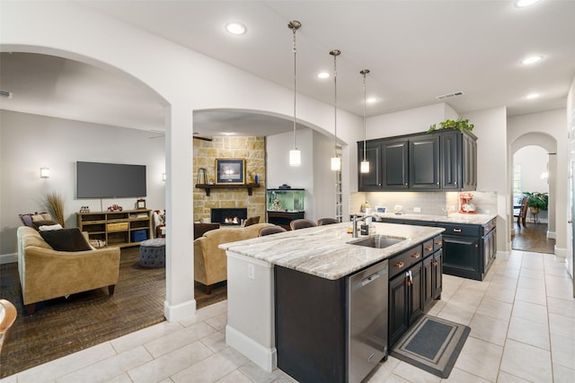 kitchen with open floor plan, stainless steel dishwasher, a sink, and visible vents