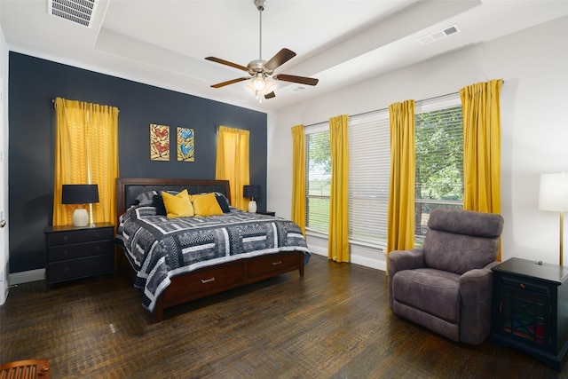 bedroom featuring a ceiling fan, a raised ceiling, visible vents, and baseboards